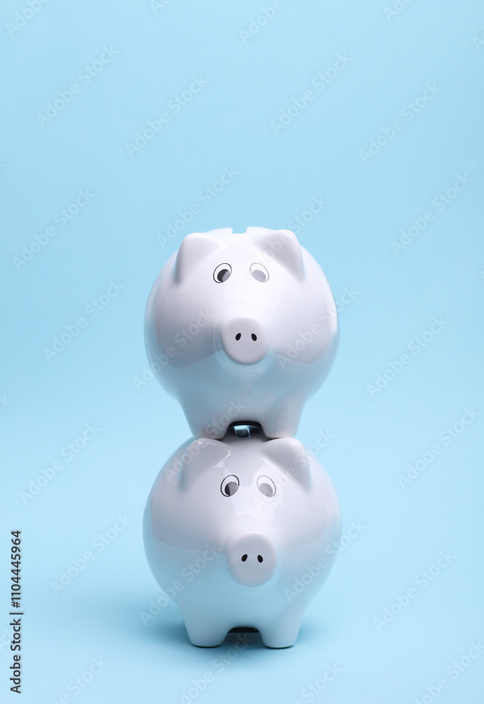 Ceramic white piggy bank on a blue background. Business concept. Conceptual photo Ceramic white piggy bank on a blue background. Business concept. Conceptual photo