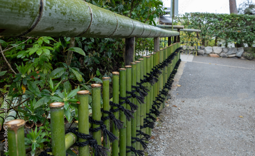 Bamboo fence vertical rods and horizontal railing. Traditional construction for Japanese garden Bamboo fence vertical rods and horizontal railing. Traditional construction for Japanese garden