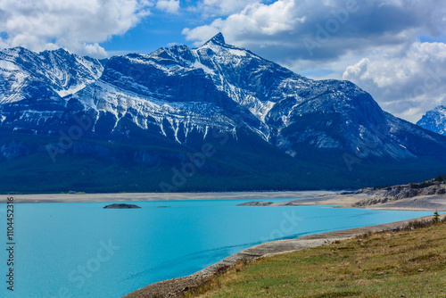 A mountain range with a blue lake in the foreground photo