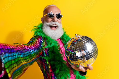 Photo of elderly cool old man take selfie photo discoball wear stylish striped suit boa sunglass isolated on yellow color background photo