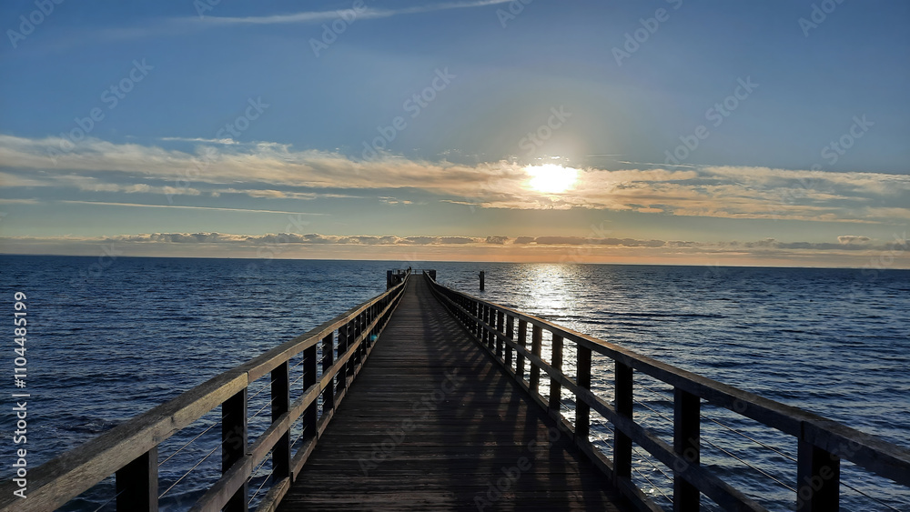 A long pier stretching out over the Pacific Ocean and reaching far into the horizon A long pier stretching out over the Pacific Ocean and reaching far into the horizon