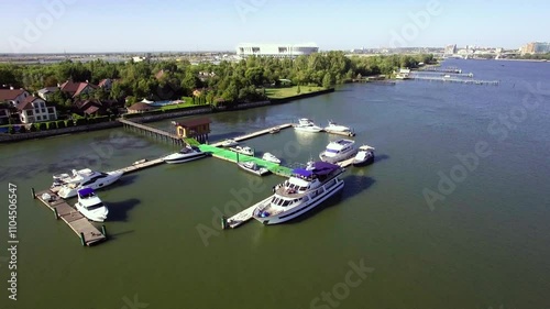 A summer day. A small marina with yachts and a hotel in the center of the frame photo