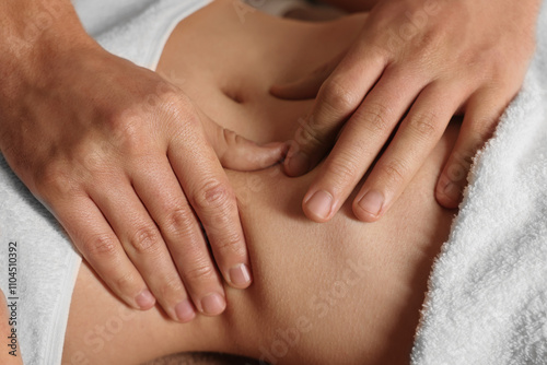 Osteopath massaging woman's belly indoors, closeup. Manual therapy