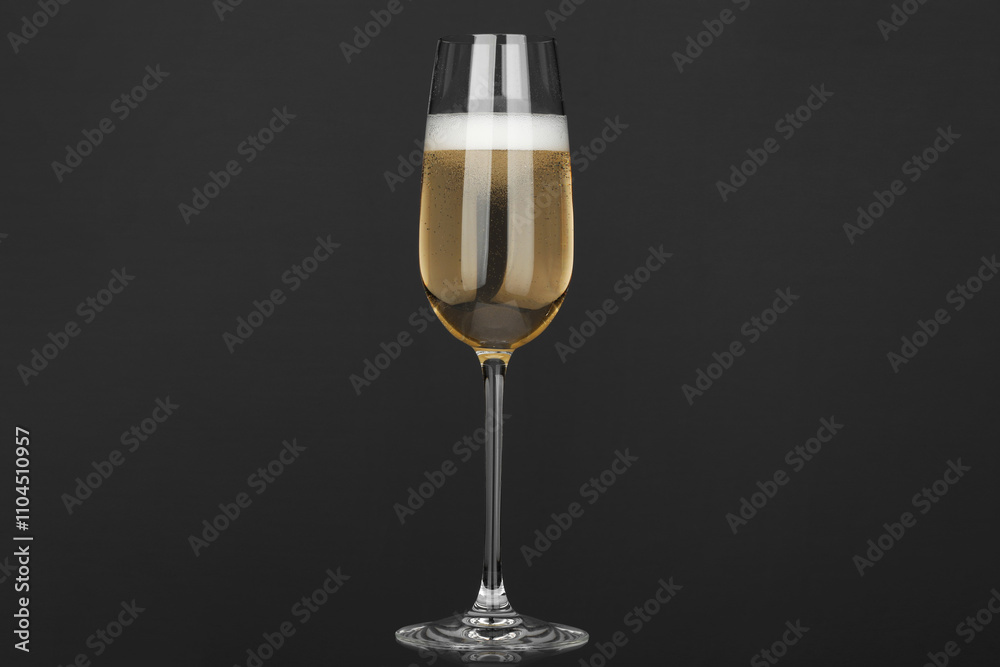 Champagne in glass on grey background. Sparkling wine Champagne in glass on grey background. Sparkling wine