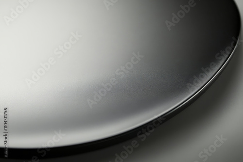 A matte black titanium surface with smooth gradients and a modern, understated finish. photo