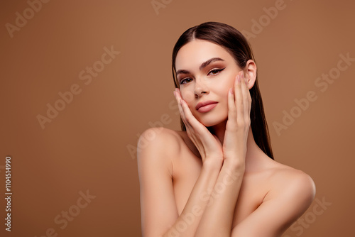 Photo of adorable seductive lady wear nothing arms cheeks apply cream empty space isolated brown color background photo