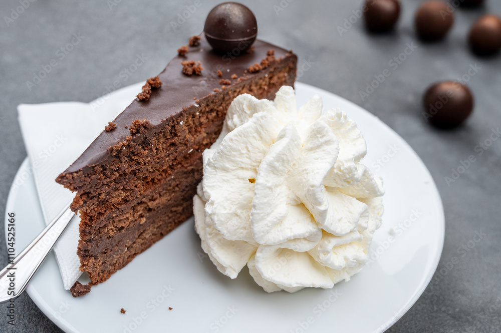 Authentic cake Sacher confectionery delicacies origin served with whipped cream.