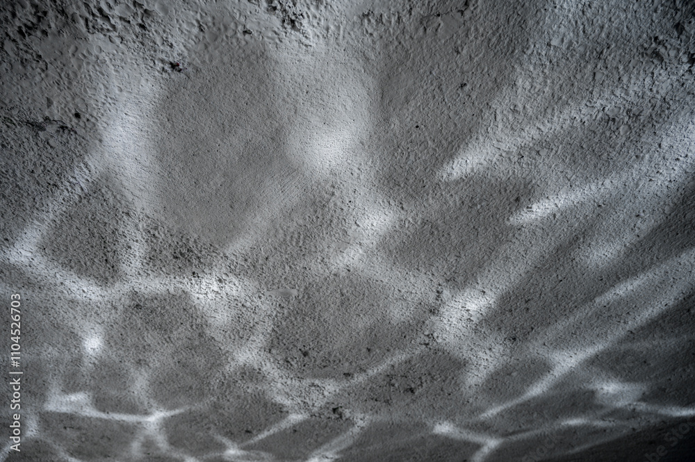 Fototapeta premium Concrete wall with light shiny stripes reflected from water. Contemporary background.