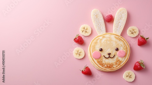 Pancake decorated as a cute bunny face with berry eyes, banana slices for ears, and a strawberry nose, cheerful children's breakfast photo