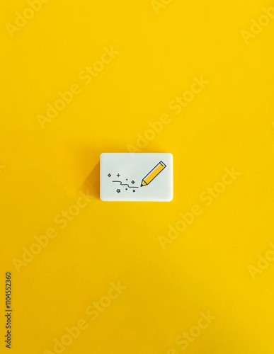 Content Creation, Creativity, Writing Motivational or Inspirational Material. A Pencil Drawing a Squiggly Line on Block Letter Tile on Yellow Background. Minimal Aesthetic.