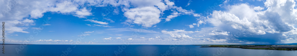 Extremely wide aerial panorama view of a large blue lake with a puffy white clouds
Extremely wide aerial panorama view of a large blue lake with a puffy white clouds