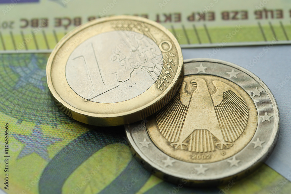 Different coins on euro banknotes, closeup view Different coins on euro banknotes, closeup view