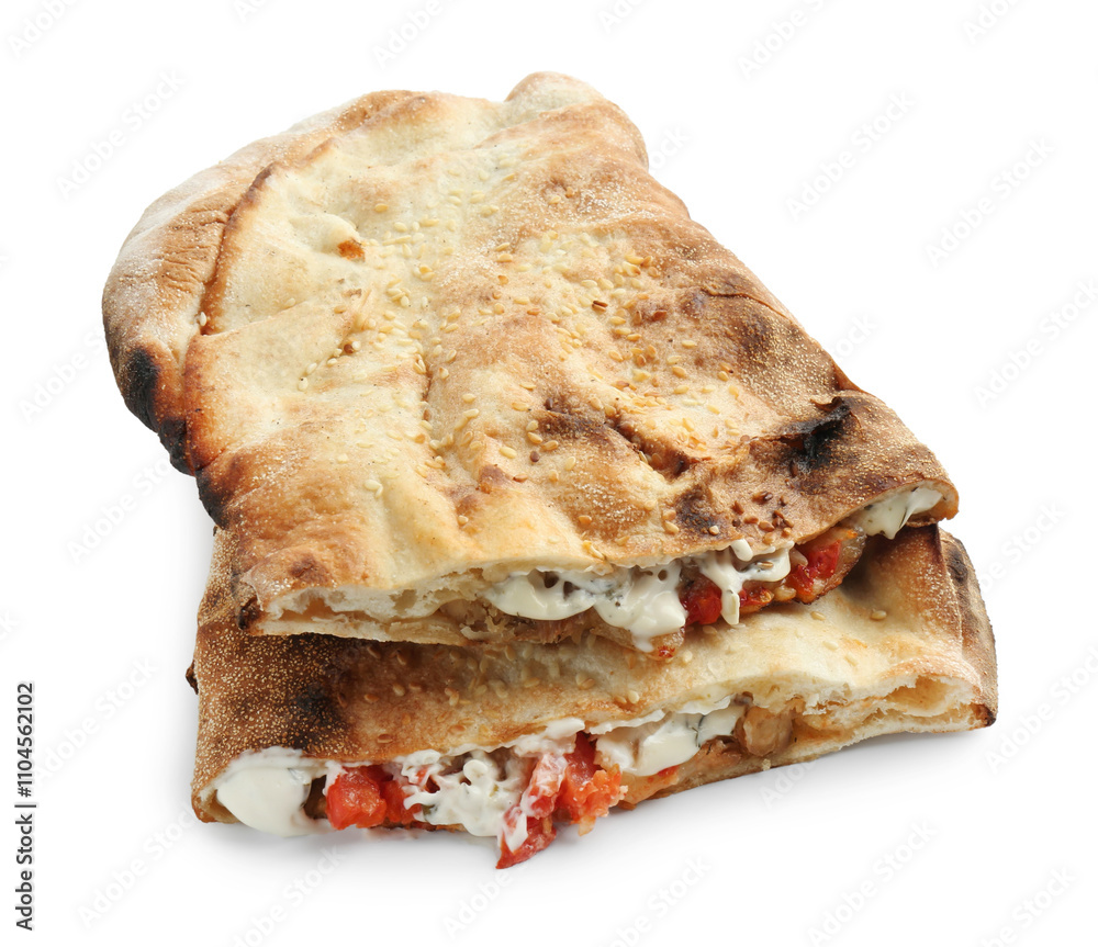 Halves of tasty calzone with meat, cheese, sauce and tomato isolated on white Halves of tasty calzone with meat, cheese, sauce and tomato isolated on white