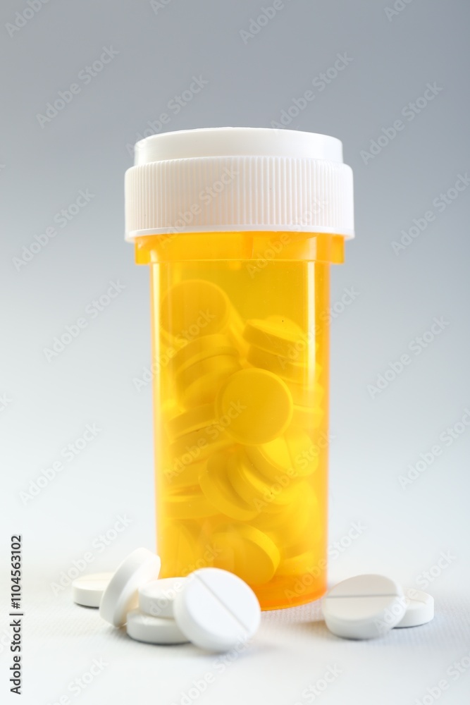 Medical bottle with antibiotic pills on grey background Medical bottle with antibiotic pills on grey background