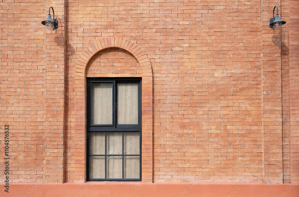 Orange brick wall decorated with arched frame and mirror window inside. Orange brick wall decorated with arched frame and mirror window inside.