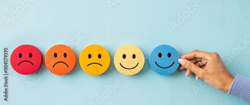 Colorful emotion faces from sad to happy on blue background