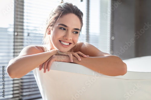 Home Spa. Portrait Of Smiling Young Female Resting In Bathtub, Beautiful Millennial Woman Relaxing In Modern Bathroom Interior, Happy Lady Enjoying Taking Hot Bath, Closeup Shot With Free Space