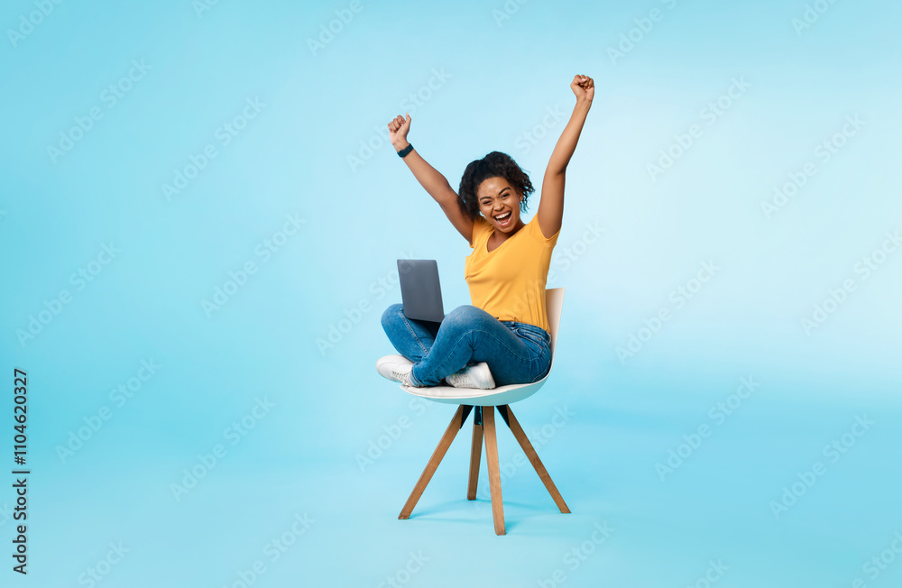 Big win, success, amazing online offer. Excited young woman sitting on chair with laptop, raising hands up, screaming, winning casino bet or online game, shopping on web, free space Big win, success, amazing online offer. Excited young woman sitting on chair with laptop, raising hands up, screaming, winning casino bet or online game, shopping on web, free space