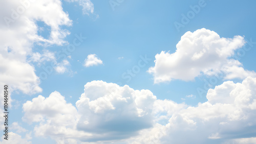 A serene sky background with fluffy, soft white clouds scattered 