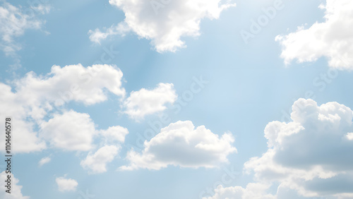 A serene sky background with fluffy, soft white clouds scattered 