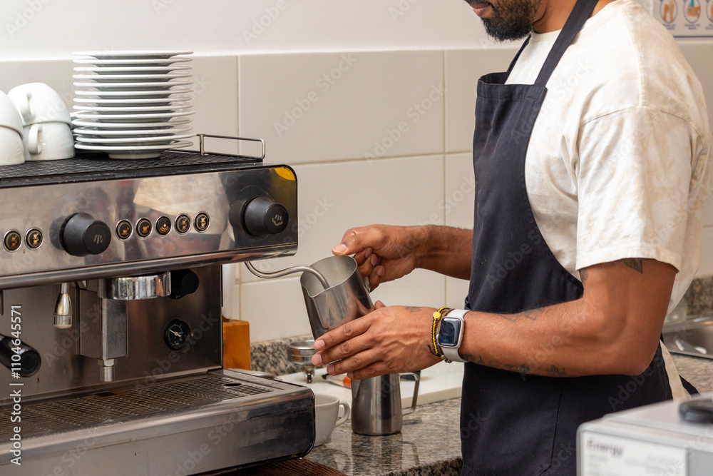 Barista frothing milk in coffee shop with espresso machine