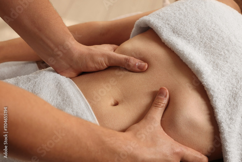 Osteopath massaging woman's belly indoors, closeup. Manual therapy