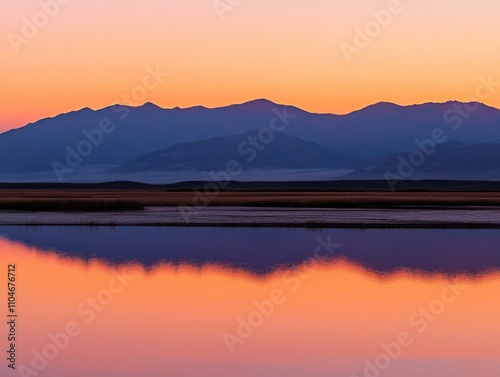 serene landscape at sunset with mountains reflecting in calm water