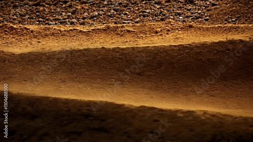 Textured layers of brown earth showcasing natural patterns at sunset creating a serene landscape in the countryside