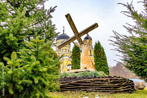 Sculpture Jesus Christ carrying his cross, old monastery Hincu in Moldova. Background with selective focus photo