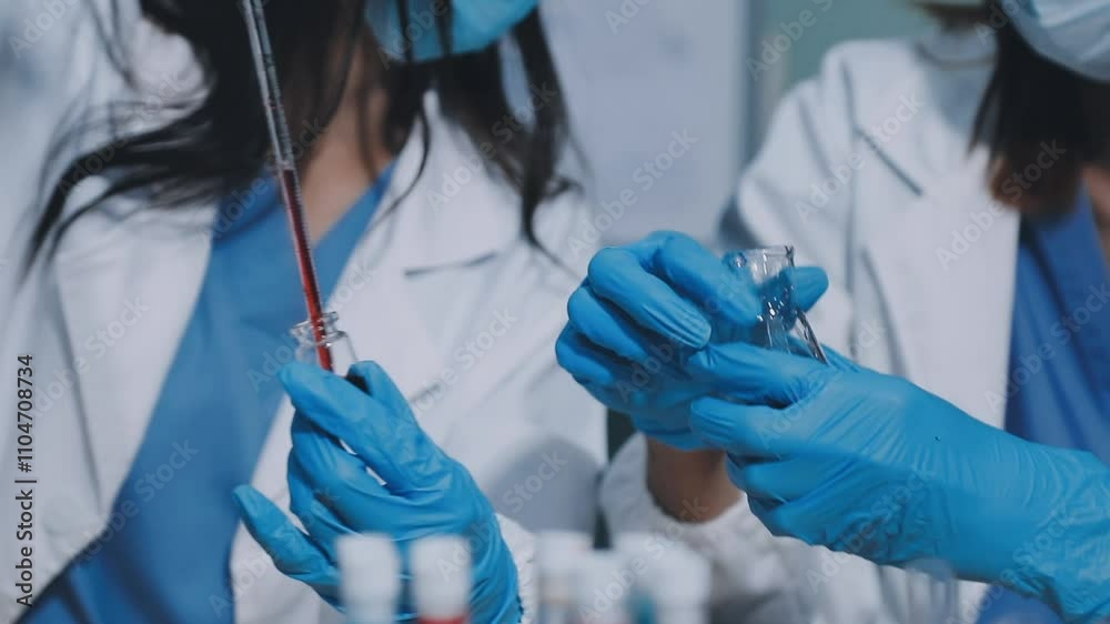 Medical development research laboratory, chemist or science scientist student hand in glove, drop water into pipette for test analysis liquid sample in clinic lab. Microbiology, analysing for medicine Medical development research laboratory, chemist or science scientist student hand in glove, drop water into pipette for test analysis liquid sample in clinic lab. Microbiology, analysing for medicine