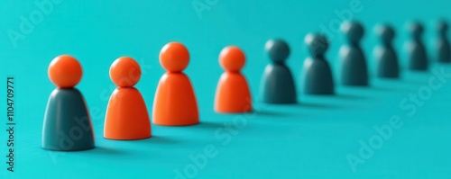 Colorful figurines in a line against a teal backdrop, representing unity, diversity, or teamwork in a modern design.