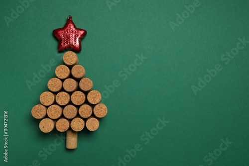 Christmas tree shaped wine corks on color background. Top view with copy space for text