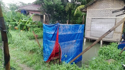 Local houses in the village with ornaments made of bamboo, traditional bathrooms. Next to the house there are coconut trees,and around it there are traditional fish farms.Buildings and natural scenery
