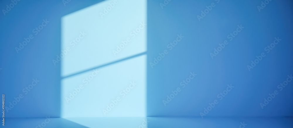 Simple blue room interior with light shadows on walls and floor, creating soft, serene ambiance. product display, branding mockups, or creative projects needing clean, minimalistic background