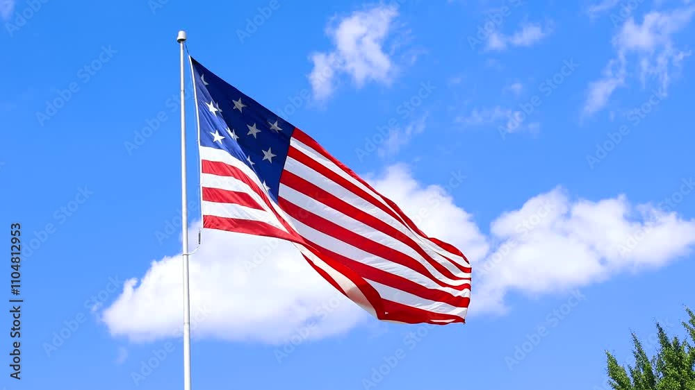 Close up view of USA flag waving against blue sky Close up view of USA flag waving against blue sky
