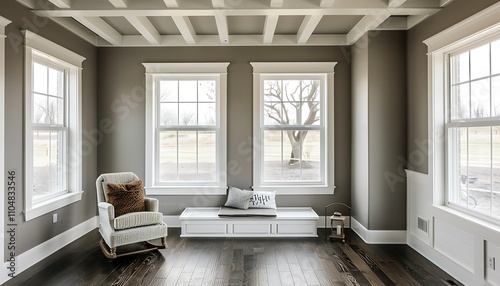 Sunroom with white windows, gray walls, dark wood floors, small window seat, white beamed ceiling, home decor.