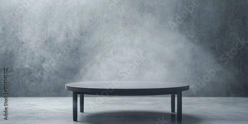 A minimalistic round table stands on a smooth surface, surrounded by a misty gray background, creating a serene and modern atmosphere.