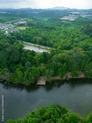 Aerial drone view of Chatin Lake or Tasik Chatin surrounded by greenery trees at Mentakab, Pahang, Malaysia. photo