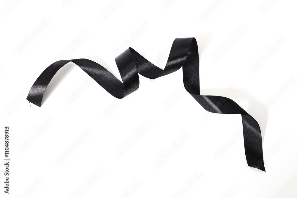 Elegant black ribbon with a smooth texture curling gracefully. Elegant black ribbon with a smooth texture curling gracefully.