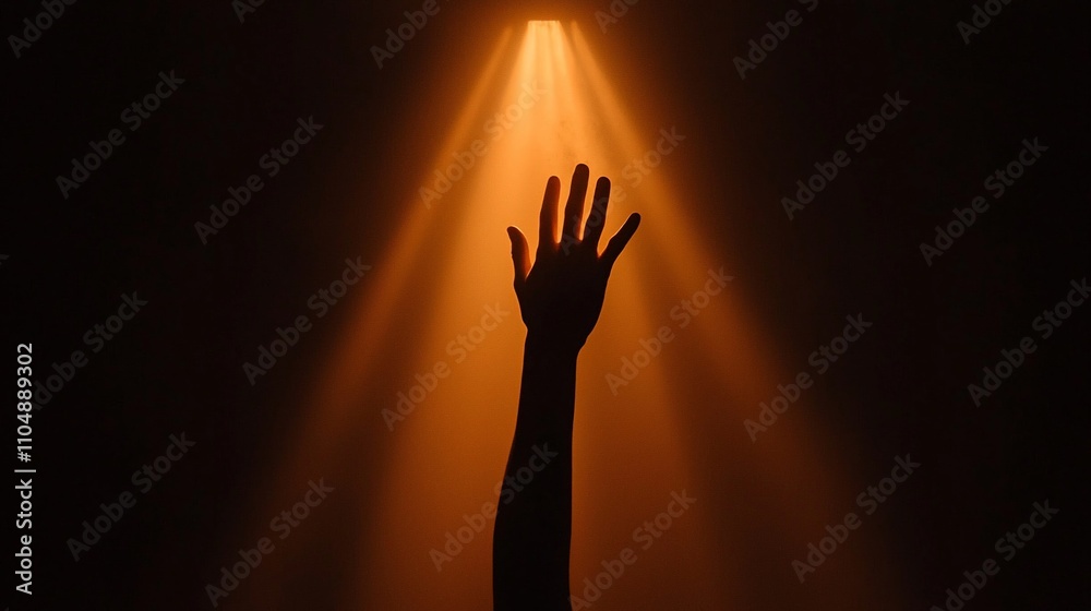 Silhouette of a hand reaching up towards a bright light. Silhouette of a hand reaching up towards a bright light.