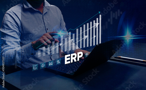 ERP Cloud System Software Automation: A businessman analyzes Enterprise Resource Planning (ERP) software or applications on a virtual screen using his laptop.