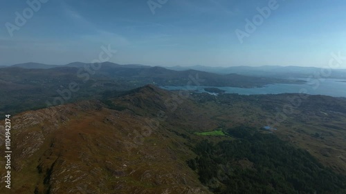 Sugarloaf, Caha Mountains, County Cork, Ireland, September 2024. Drone tracks left above the craggy peaks with the North Atlantic Ocean to the south and Glengarriff in the distance. photo