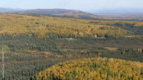 Sunny and cloudy skies over Alaskan fall landscapes, featuring colorful foliage photo