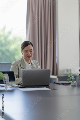 Portrait of confident Asian business woman working in office