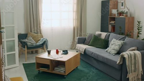 Interior of comfortable living room with diabetic supplies on small wooden table next to sofa