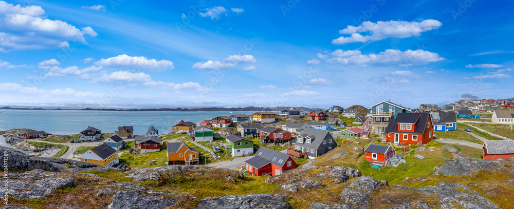 Typical architecture of Greenland capital Nuuk with colored houses located near fjords and icebergs.
