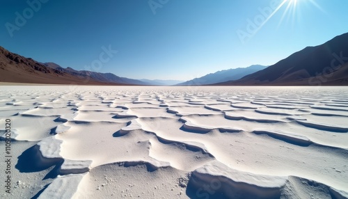 Fototapeta Naklejka Na Ścianę i Meble -  Sunlit sand dunes in a desert landscape with mountains on the horizon