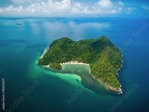 Aerial View of Beach, Chumphon island. Tropical blue ocean, dry steep mountain cliffs, blue skies with clouds. Sea waves on reef to white sand beach. Green foliage