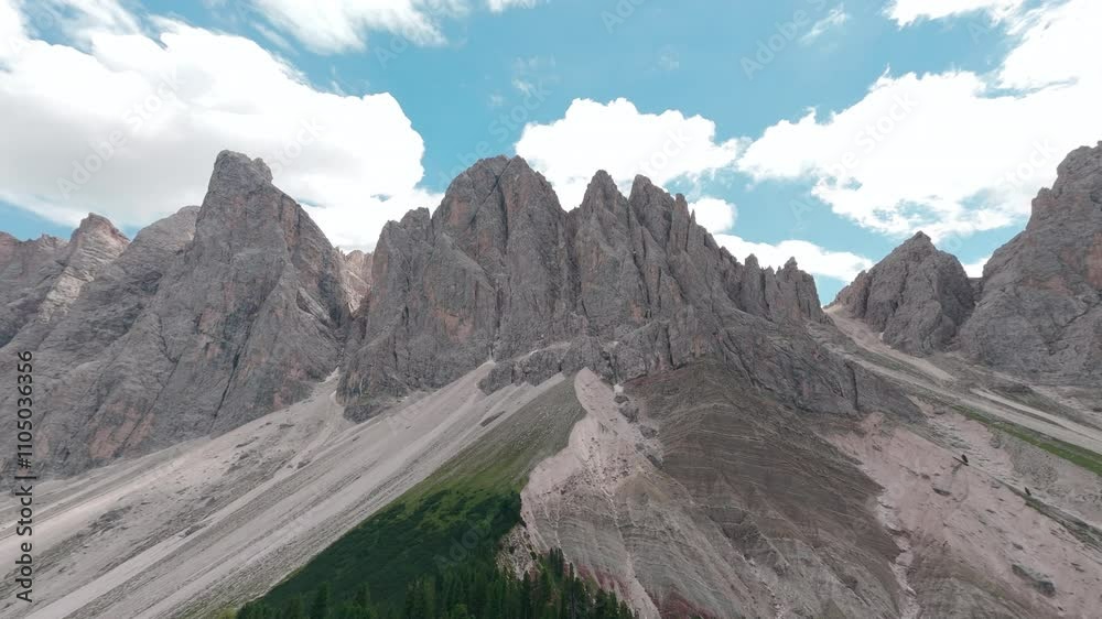 Aerial view of alpine mountain peaks and blue sky in Ortisei, Italy, on a sunny day. Aerial view of alpine mountain peaks and blue sky in Ortisei, Italy, on a sunny day.