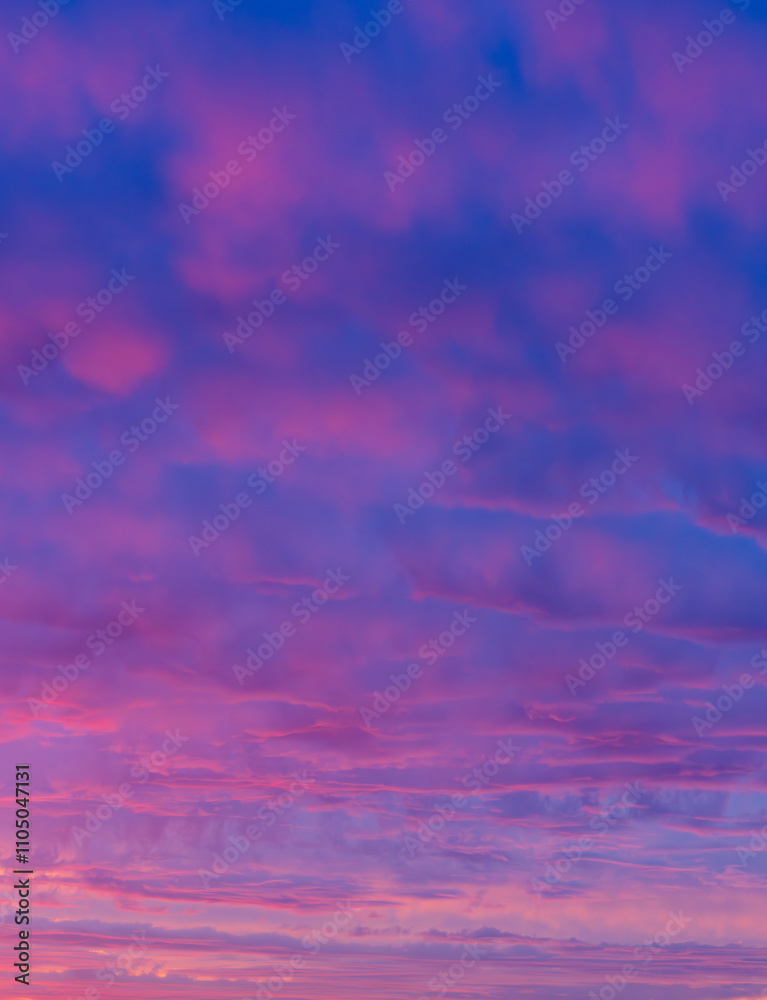 Obraz premium Vibrant Pink and Purple Sunrise Sky with Dreamy Cloudscape. Soft and Ethereal Morning Sky Colors Captured in a Peaceful Moment.
